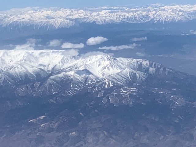 view of snow-covered Sierra mountains from airplane