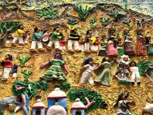 Mexican parade scene in bas relief folklore art
