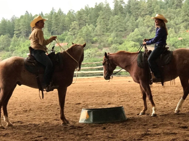 Two women demonstrating horsemanship