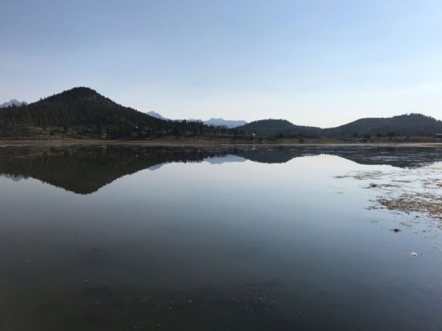 lake reflecting hills