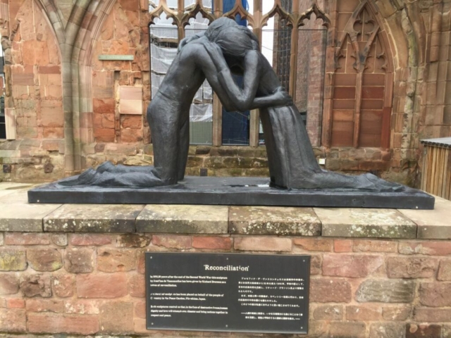 Statue of two people hugging, Coventry Cathedral ruin