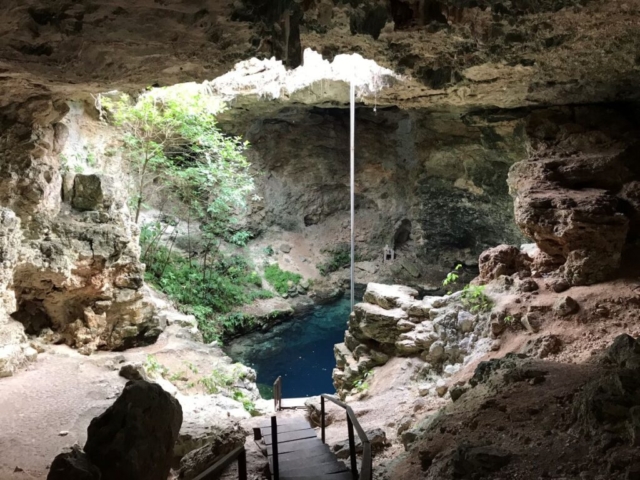 A cenote with lining shining through from above